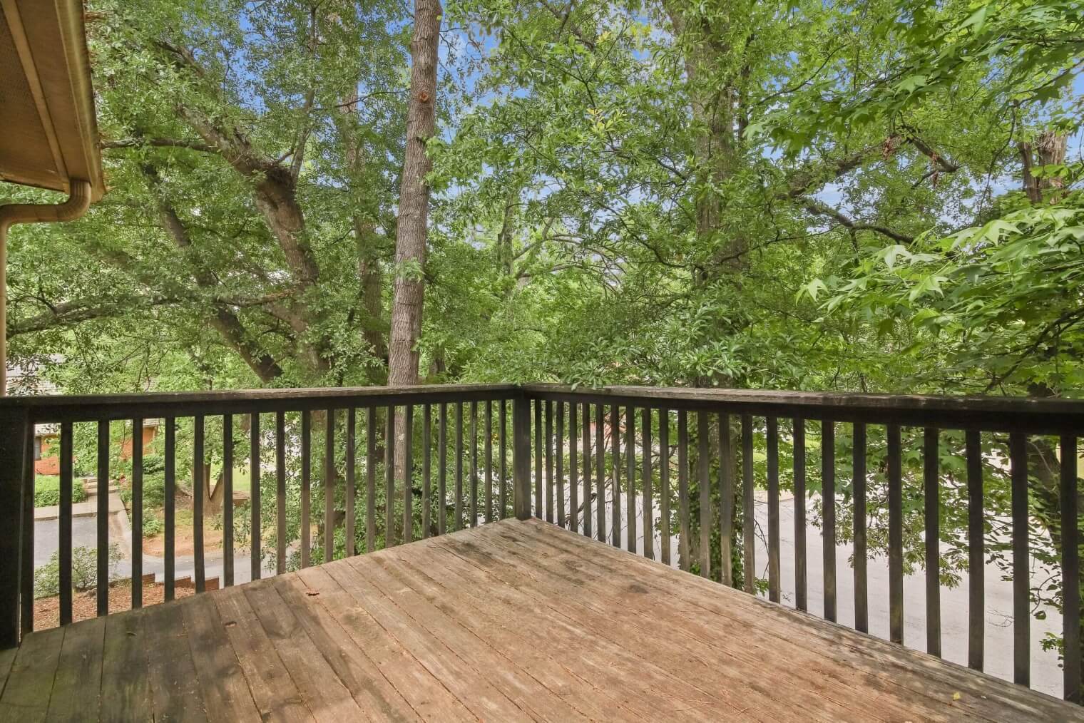 balcony overlooking trees and green space at Flourish Park Apartments in Clarkston.